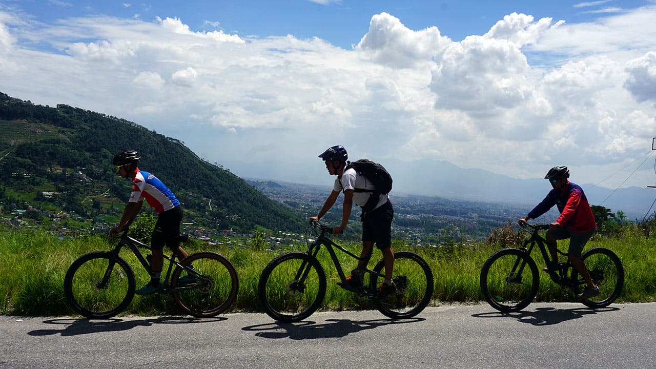 Mountain bikers riding on a hillside trail