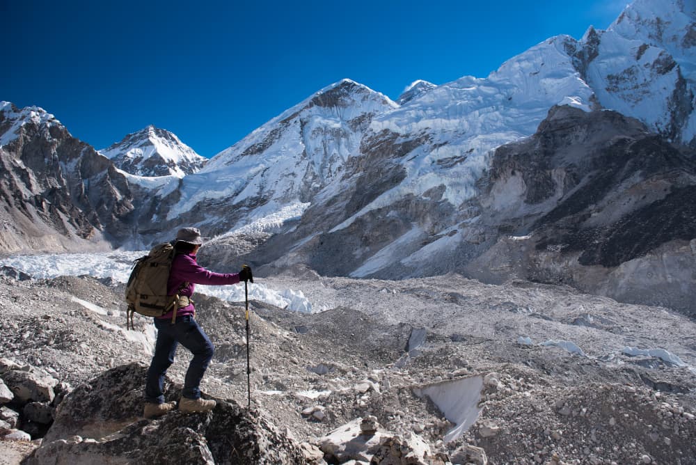 Hiker below Himalayan peaks