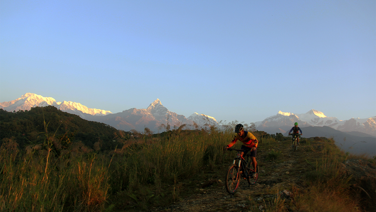 Mountain bikers enjoying the sunrise down-hill from Sarangkot.