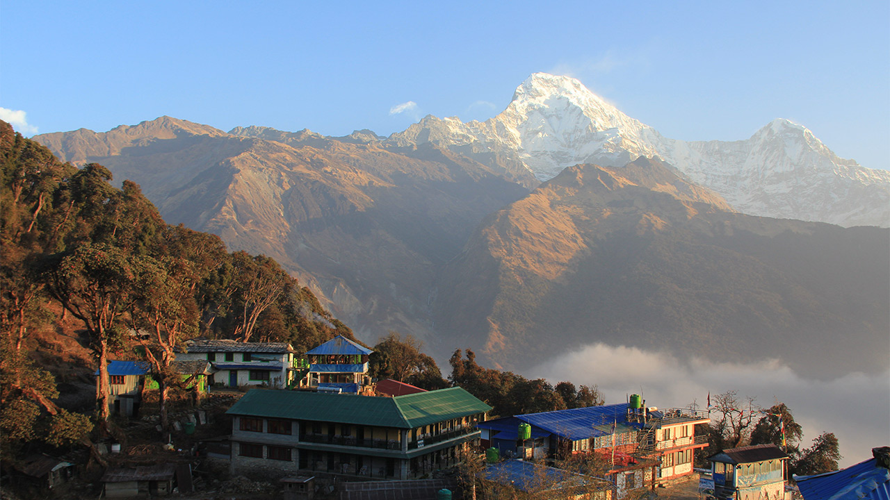 The sight of Annapurna South on the left and Hiunchuli on the right seen from the colorful village of Tadapani, Ghandruk.