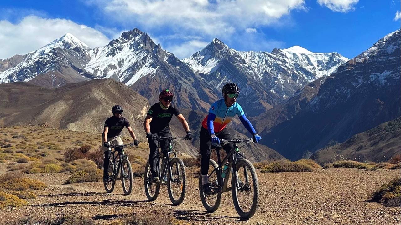 Bikers riding the Lupra singletrack during Lower Mustang mountain bike tour in the Himalayas of Nepal.