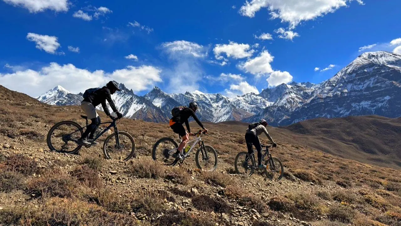 Mountain bikers are rolling down the Lupra singletrack in Mustang during the Himalayan MTB Adventure in Nepal.