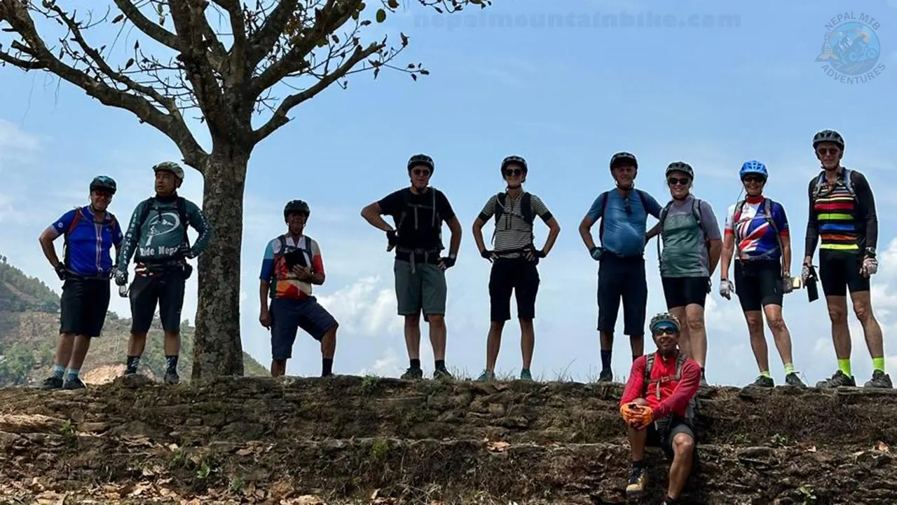 A group of mountain bikers posing for a picture during the mountain bike tour in the Himalayas of Nepal.