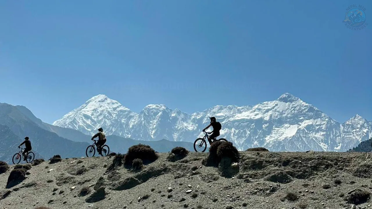 Mountain bikers are riding through the rugged trail of Mustang during Himalayan MTB expedition in Nepal.