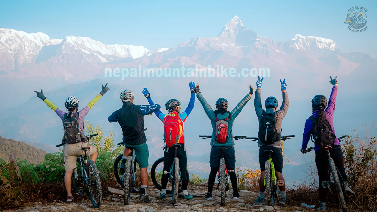 Group of mountain bikers are cheering the mountain view in Pokhara during their mountain biking tour in Nepal.