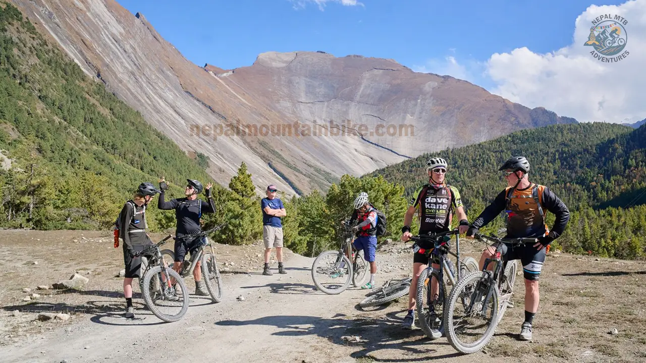 Mountain bikers are stopping to enjoy the surrounding views during the Annapurna Circuit high-altitude mountain biking tour in Nepal.