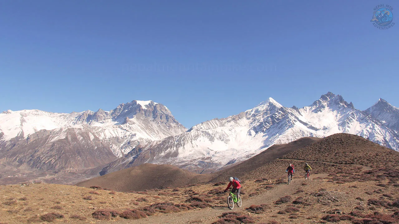 Mountain bikers are rolling down the epic Lupra singletrack in Mustang during Nepal Enduro MTB tour in the Himalayas.