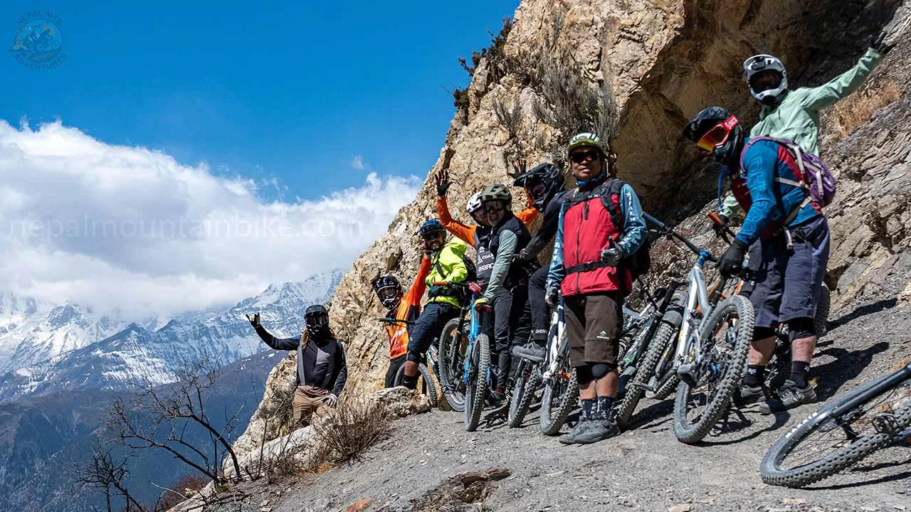 Group of mountain bikers taking picture during Enduro MTB tour package in the Himalayas of Nepal.