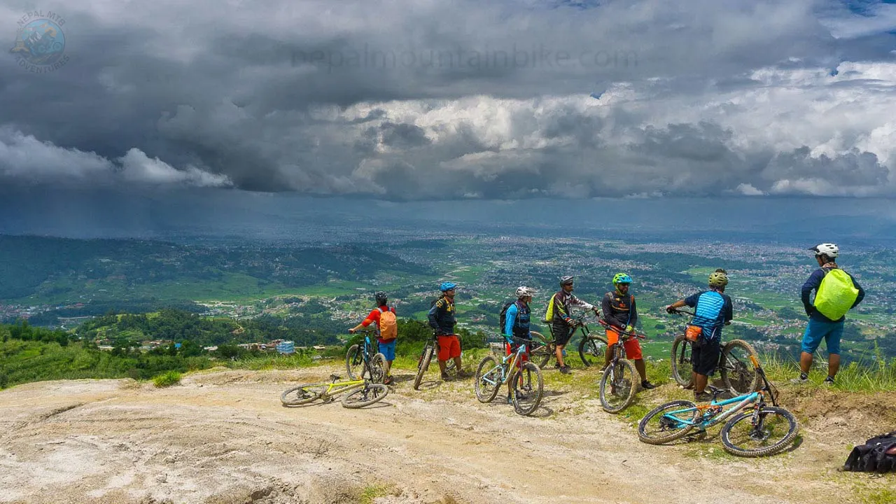 Mountain bikers are stopping to enjoy the view of Kathmandu during Nepal MTB Adventure.