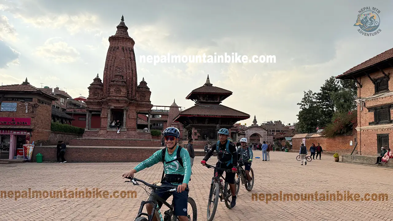 Mountain bikers cruising at Hanuman Durbar Square during Kathmandu valley mountain biking tour in Nepal.