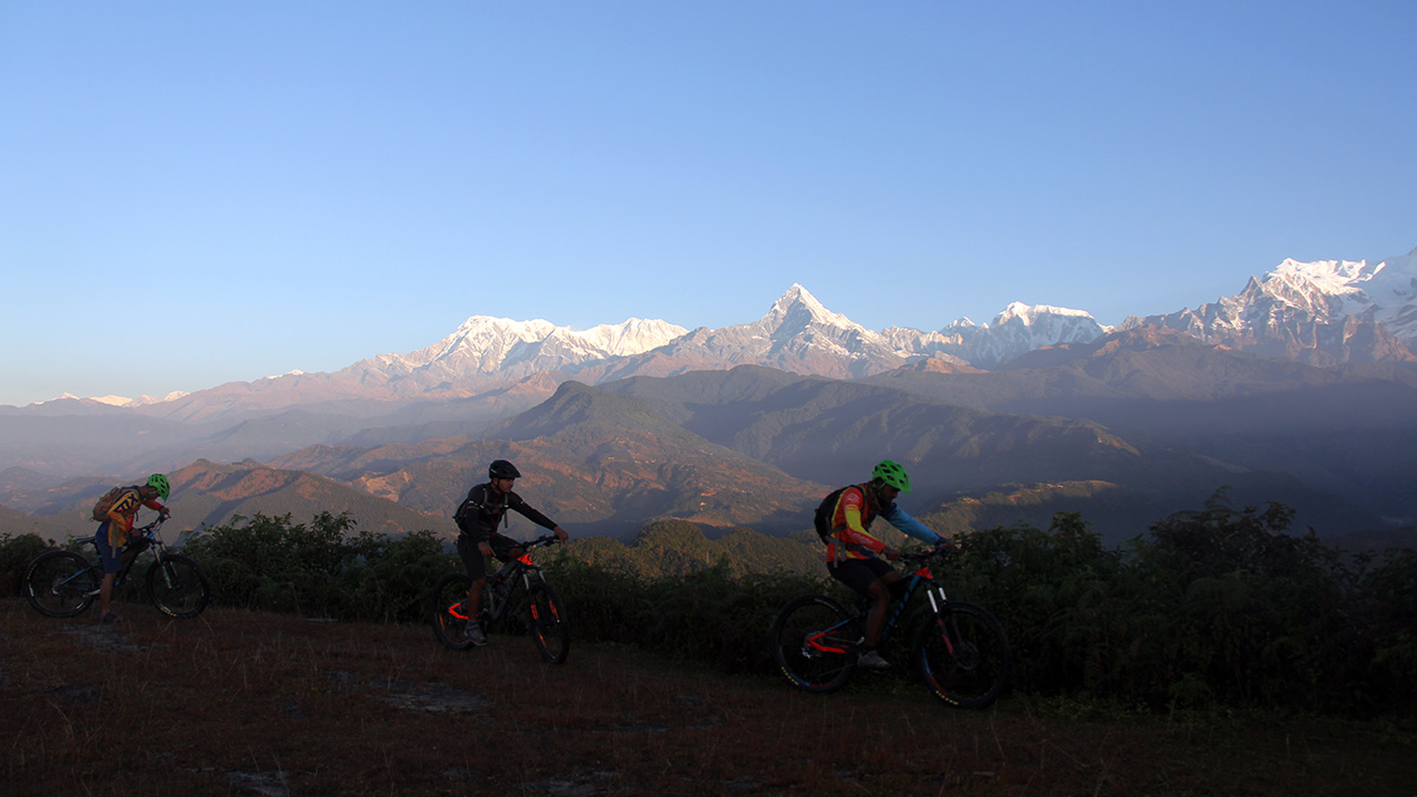 Mountain bikers are starting their ride with the view of Annapurna and Fishtail to Begnas Lake.