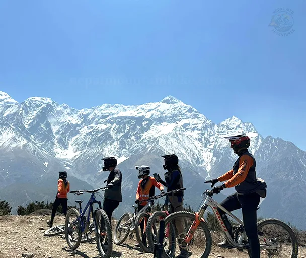 Mountain bikers riding through scenic Himalayan trails with Nepal MTB Adventures during Mustang Epic Enduro Tour.