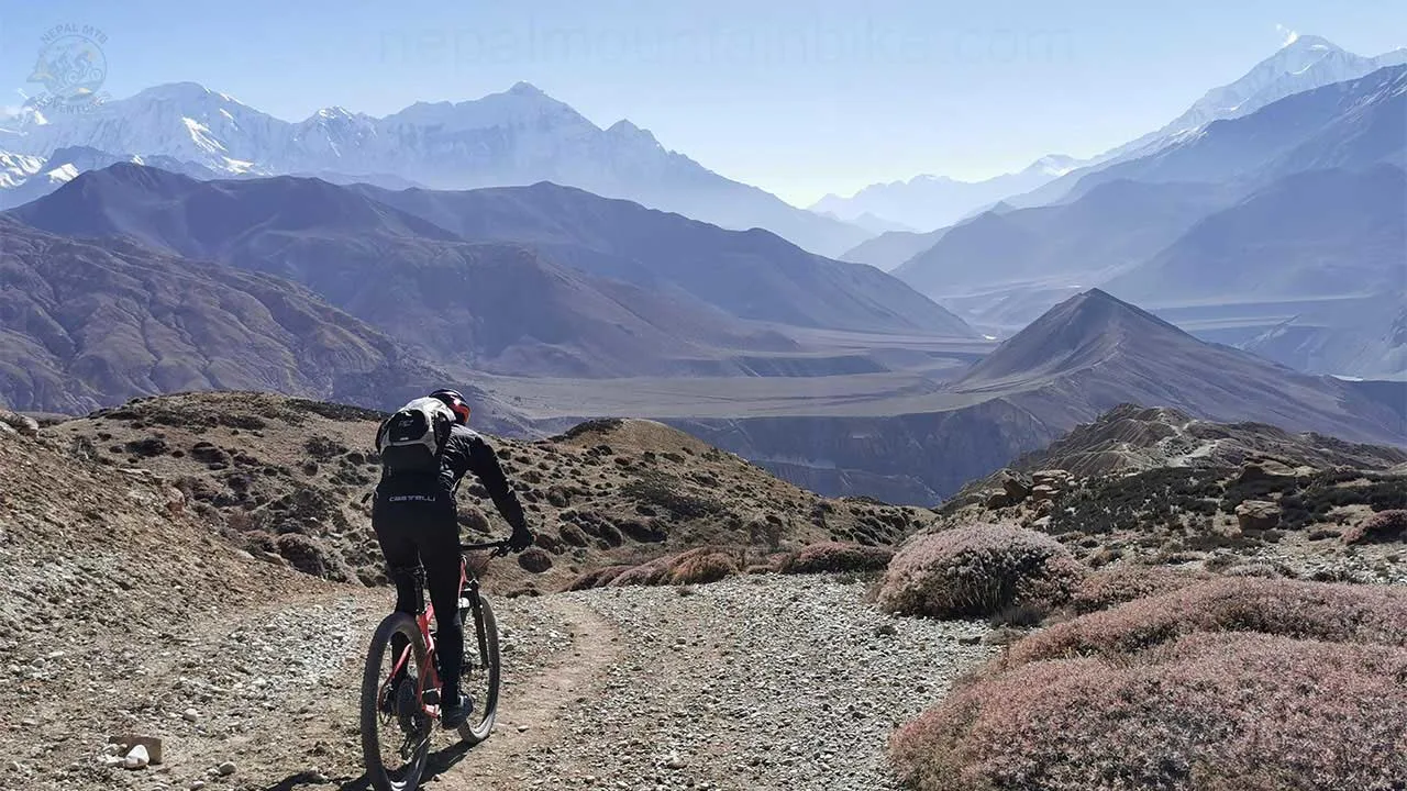 A MTB rider bikes through the rugged trail of Upper Mustang during the Himalayan mountain bike tour in Nepal.