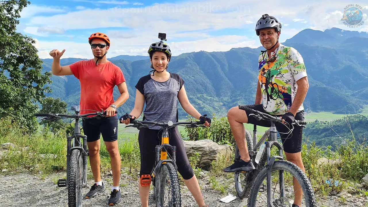 Three mountain bikers getting ready for a picture with their bikes during the mountain bike tour in Nepal.